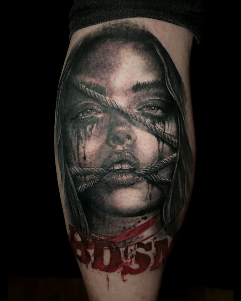 Tatuaje de un retrato de una mujer con cuerdas, con las letras BDSM, estilo realismo, tatuado por kaorukel